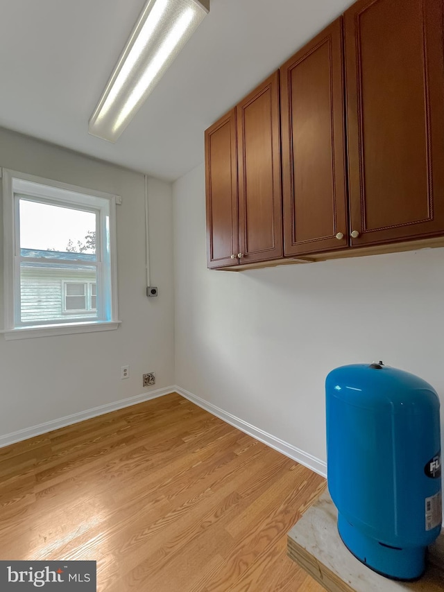 42190 Ridge Rd, Mechanicsville, MD 20659 - laundry area featuring light wood-style floors and baseboards