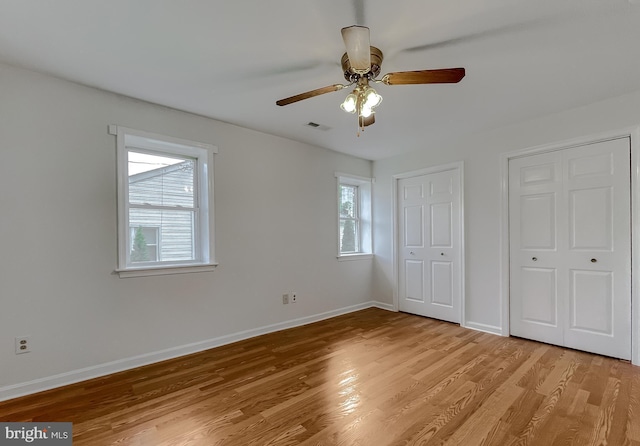 42190 Ridge Rd, Mechanicsville, MD 20659 - unfurnished bedroom with ceiling fan, visible vents, baseboards, two closets, and light wood-style floors