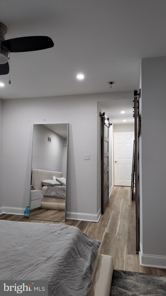 2246 N Hancock St, Philadelphia, PA 19133 - bedroom featuring light wood-type flooring, a barn door, baseboards, and recessed lighting