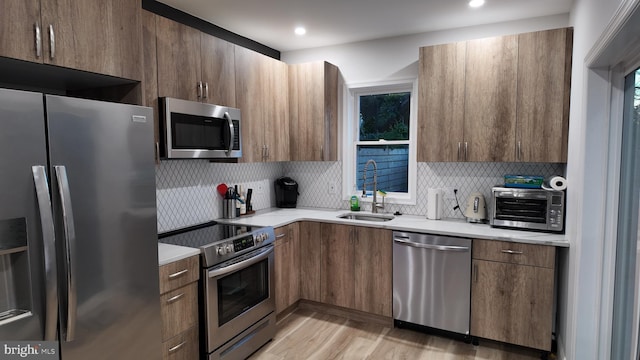 2246 N Hancock St, Philadelphia, PA 19133 - kitchen with a sink, light countertops, backsplash, and stainless steel appliances