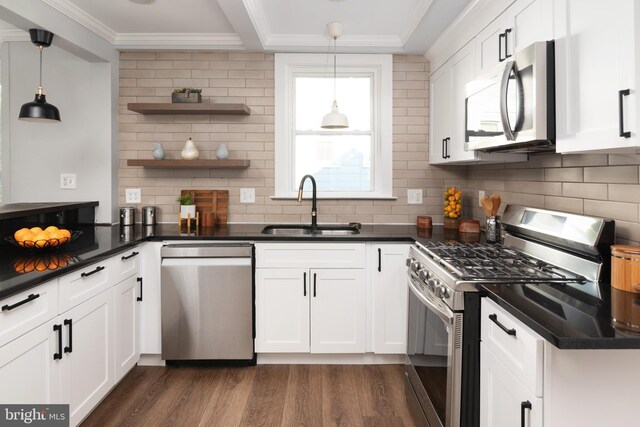 1119 Overbrook Rd, Baltimore, MD 21239 - kitchen featuring appliances with stainless steel finishes, a sink, dark countertops, dark wood-style floors, and white cabinetry