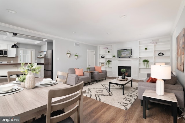 1119 Overbrook Rd, Baltimore, MD 21239 - living area with light wood-style floors, a glass covered fireplace, built in shelves, and crown molding