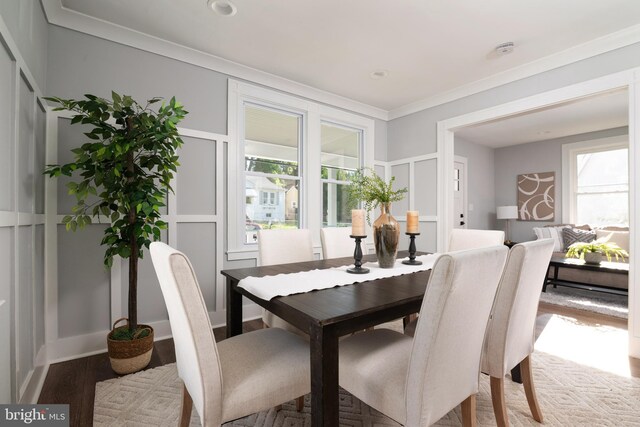 1119 Overbrook Rd, Baltimore, MD 21239 - dining area with wood finished floors, crown molding, and a decorative wall