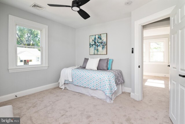 1119 Overbrook Rd, Baltimore, MD 21239 - carpeted bedroom with multiple windows, baseboards, and ceiling fan