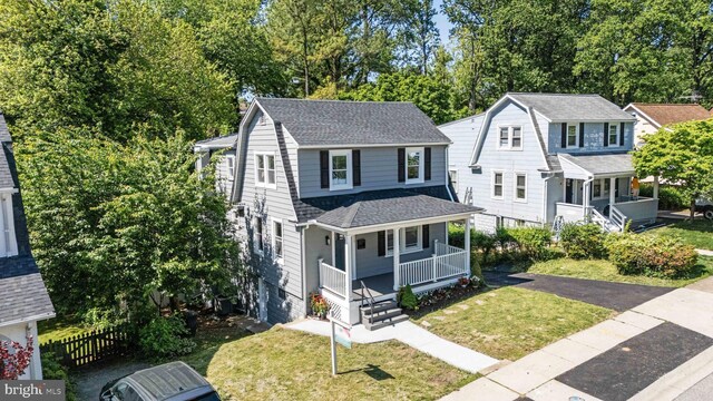 1119 Overbrook Rd, Baltimore, MD 21239 - colonial inspired home with a porch, roof with shingles, a gambrel roof, and a chimney