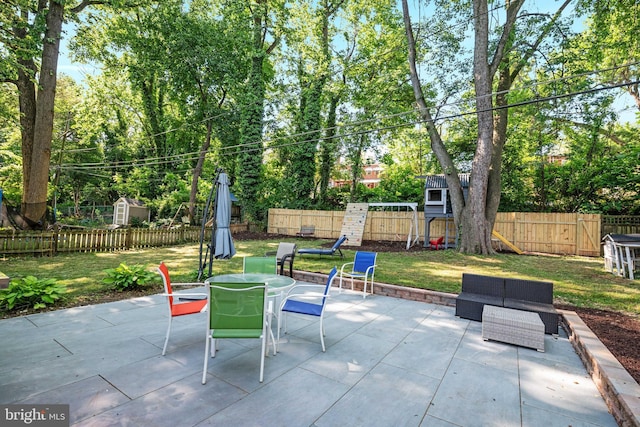 1119 Overbrook Rd, Baltimore, MD 21239 - view of patio featuring outdoor dining space, view of wooded area, and an outdoor living space