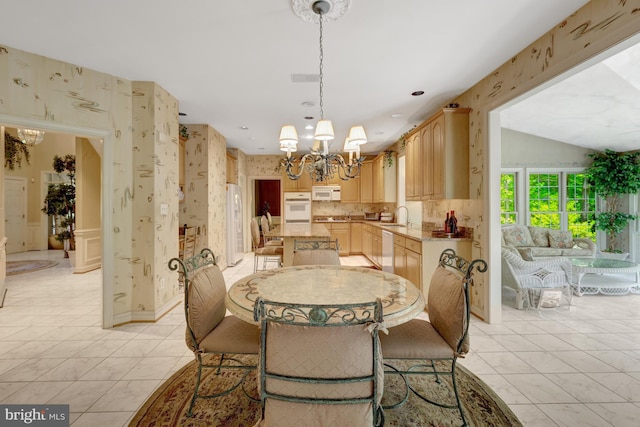 dining room featuring wallpapered walls and a notable chandelier