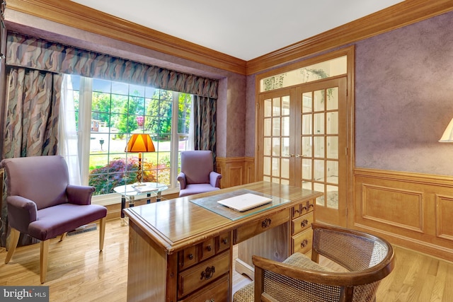 office space with light wood-type flooring, ornamental molding, wainscoting, and french doors