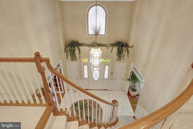 entrance foyer featuring stairs and a high ceiling