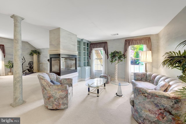 carpeted living room with a multi sided fireplace, decorative columns, and visible vents