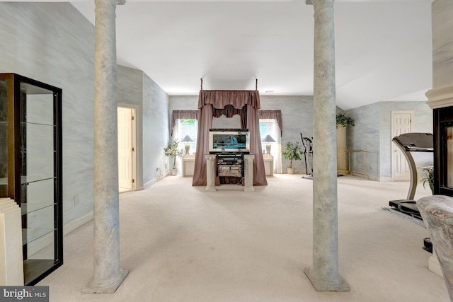 carpeted living room featuring baseboards and decorative columns