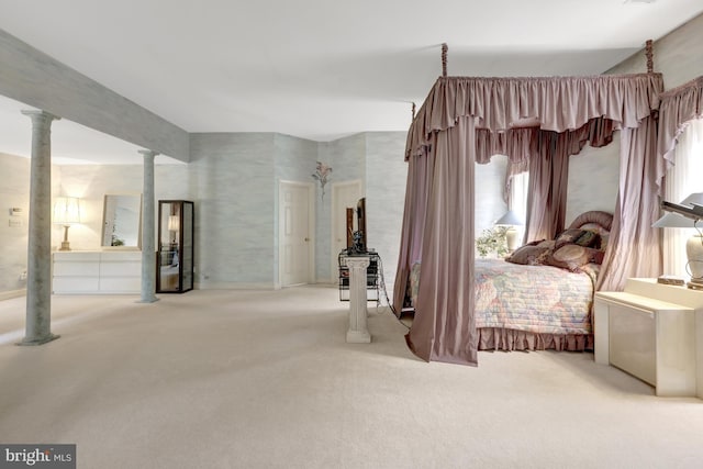bedroom with ornate columns and carpet flooring