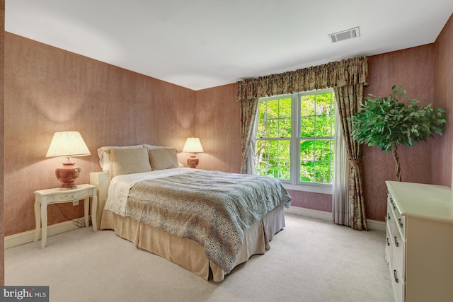 bedroom with light colored carpet, baseboards, and visible vents