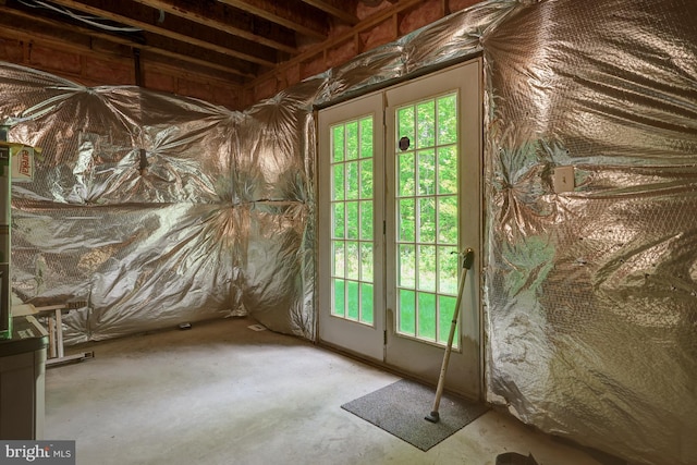 doorway with unfinished concrete flooring