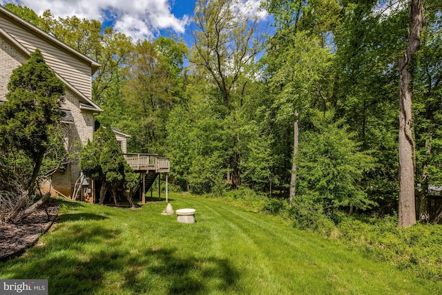 view of yard with stairs and a deck