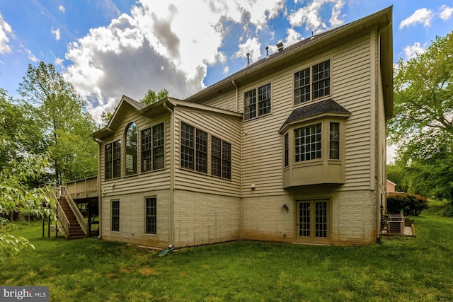 back of house with a lawn, stairs, french doors, and a wooden deck
