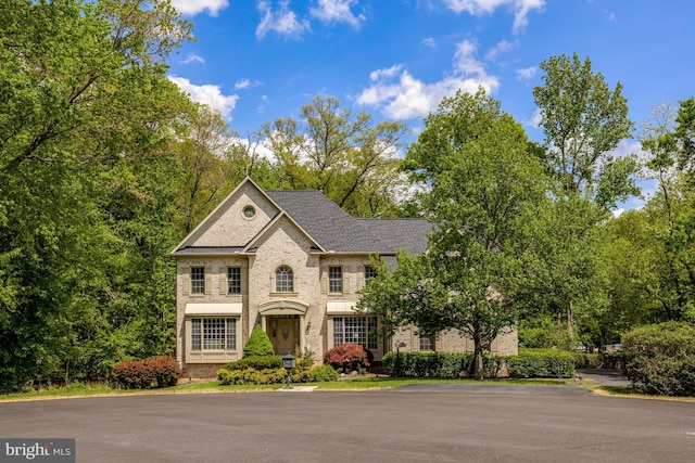 colonial-style house with brick siding