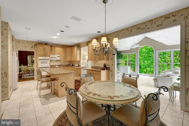dining space featuring an inviting chandelier, recessed lighting, wallpapered walls, and visible vents
