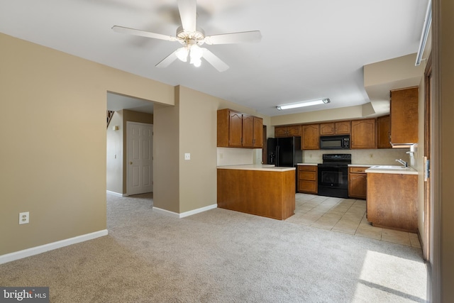 kitchen with ceiling fan, brown cabinetry, light countertops, black appliances, and light carpet