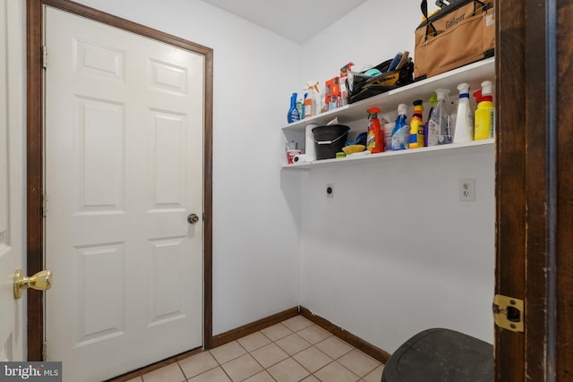 laundry area with laundry area, baseboards, light tile patterned floors, and hookup for an electric dryer