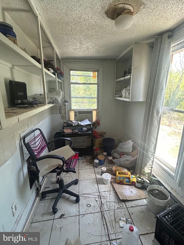 home office with a textured ceiling and cooling unit