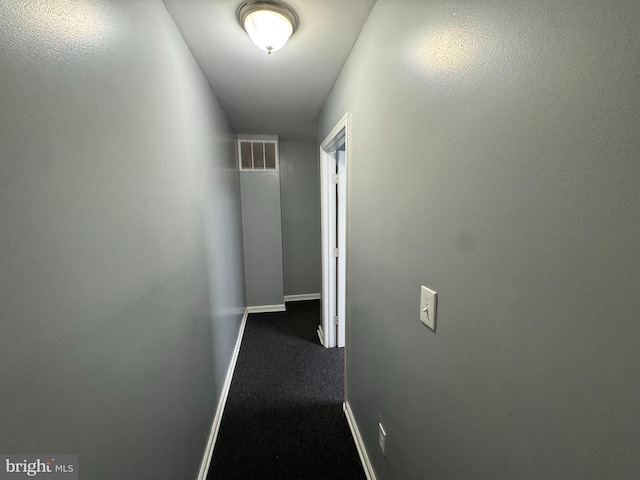 hall with baseboards and carpet flooring