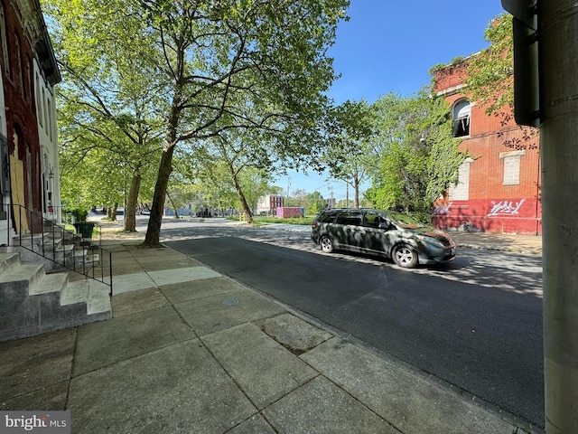 view of asphalt street featuring sidewalks