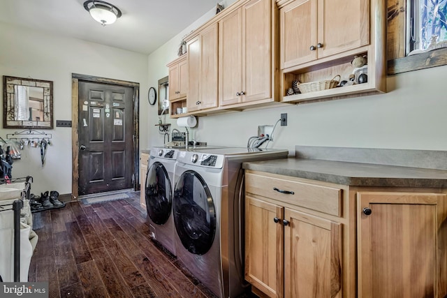 laundry area with dark wood finished floors, washer and dryer, and cabinet space