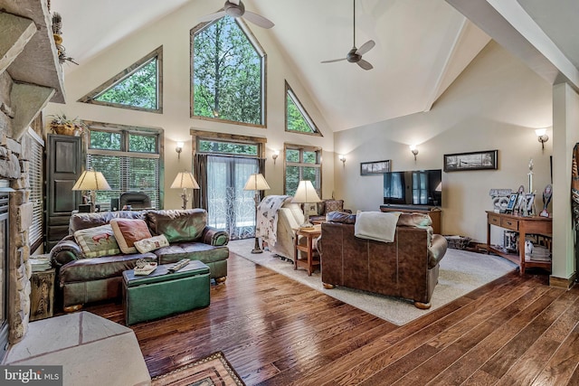 living area with high vaulted ceiling, a fireplace, wood-type flooring, and a ceiling fan