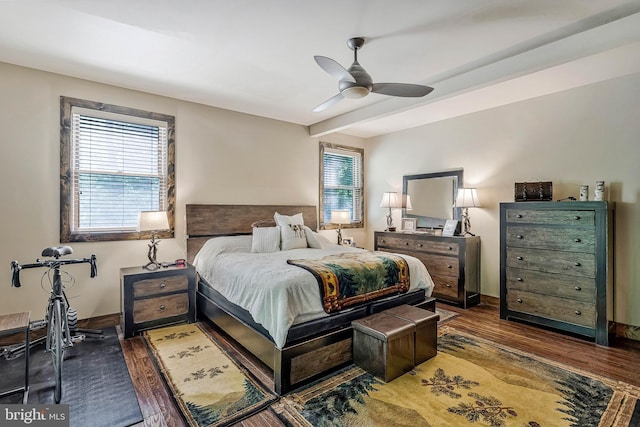 bedroom with ceiling fan, baseboards, and wood finished floors