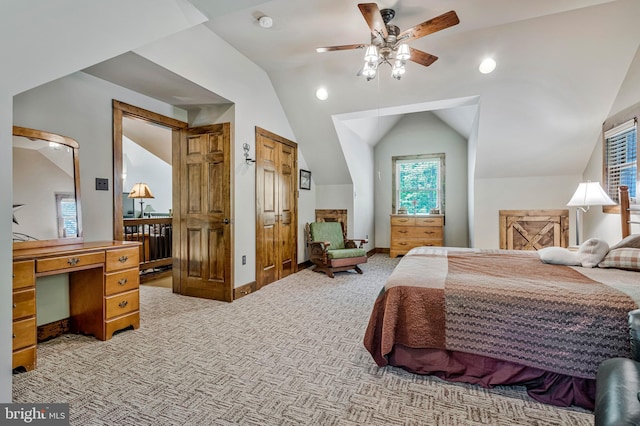 bedroom with vaulted ceiling, light carpet, baseboards, and a ceiling fan