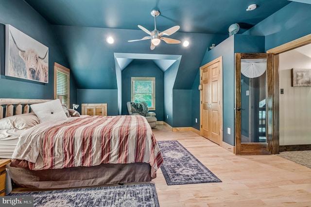 bedroom with lofted ceiling, baseboards, ceiling fan, and wood finished floors