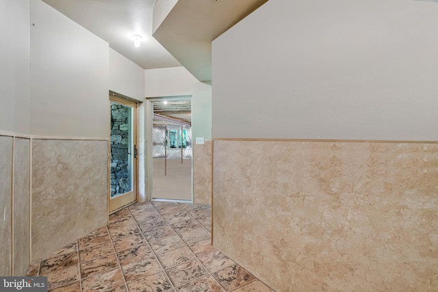 bathroom with a wainscoted wall