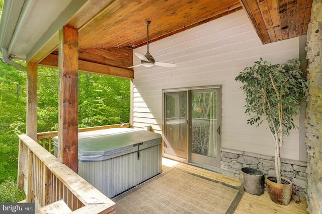 view of patio with a ceiling fan and a hot tub