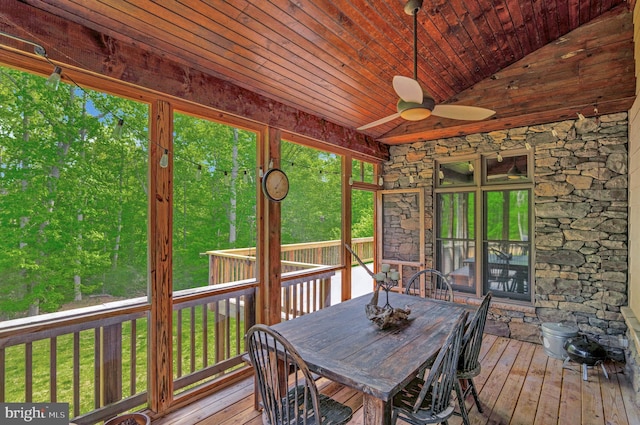 sunroom / solarium featuring ceiling fan and outdoor dining area
