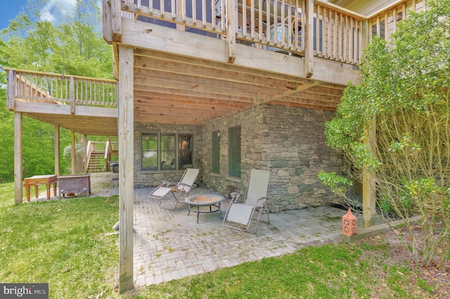 view of patio / terrace with a deck, stairway, and a fire pit