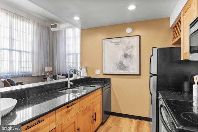 kitchen with a sink, appliances with stainless steel finishes, healthy amount of natural light, and recessed lighting