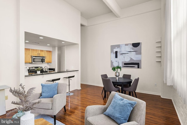 dining area featuring beam ceiling, dark wood-style floors, baseboards, and recessed lighting