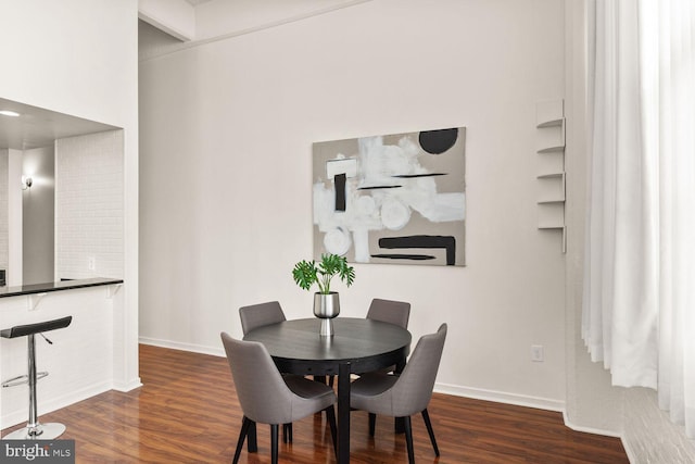 dining room featuring wood finished floors and baseboards