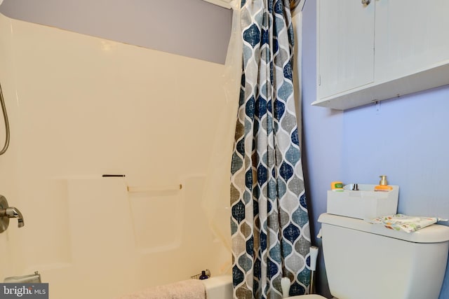 bathroom with toilet and shower / tub combo with curtain