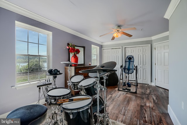 playroom with a ceiling fan, ornamental molding, plenty of natural light, and wood finished floors