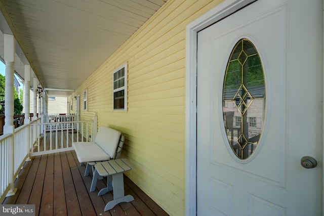 wooden terrace featuring covered porch