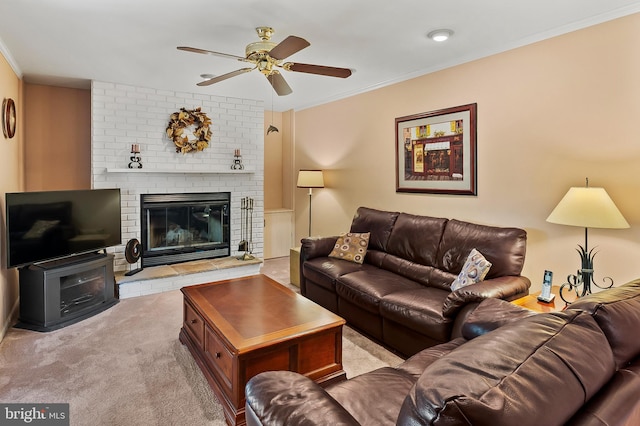 living room with crown molding, a ceiling fan, light carpet, and a fireplace