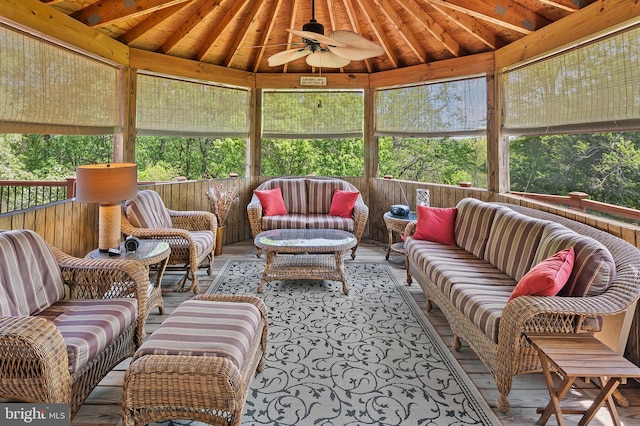 sunroom with ceiling fan, a healthy amount of sunlight, and outdoor lounge area