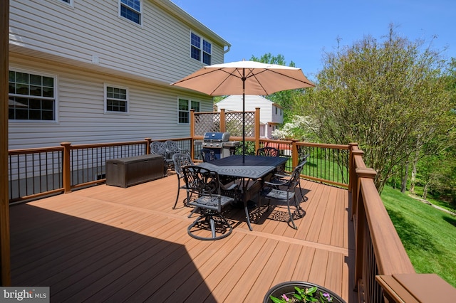 wooden deck with a lawn and outdoor dining area