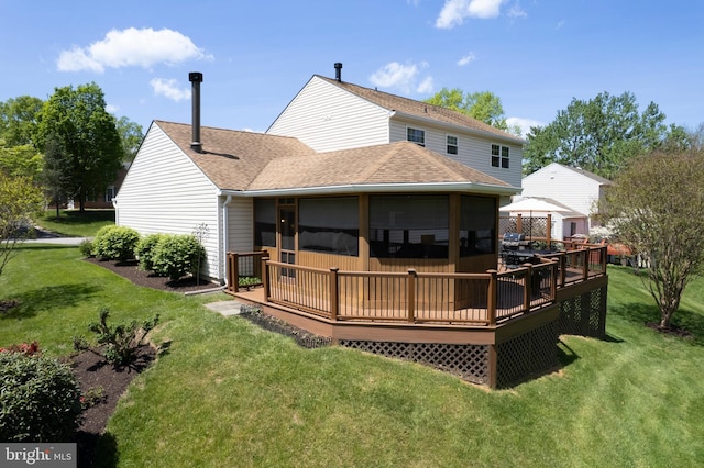 back of house with a shingled roof, a yard, and a deck