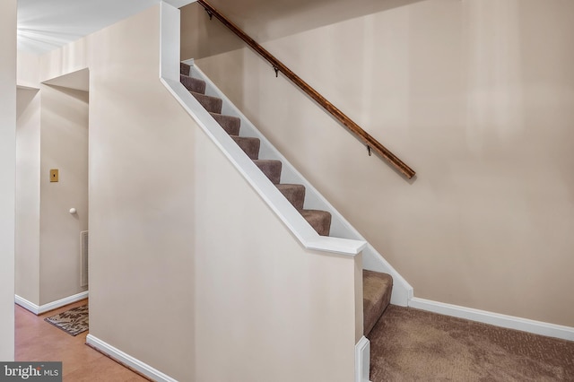 stairs with visible vents and baseboards