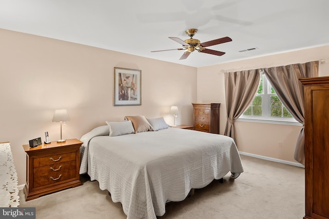 bedroom featuring baseboards, a ceiling fan, light colored carpet, and visible vents