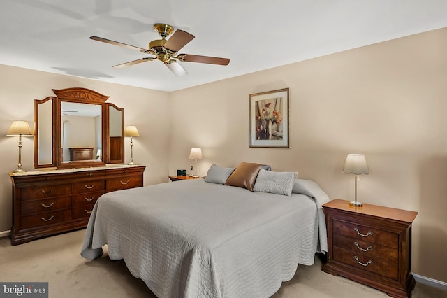 bedroom featuring a ceiling fan, baseboards, and light carpet