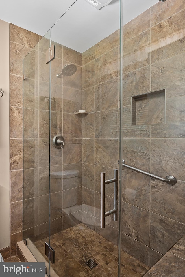 bathroom with a shower stall